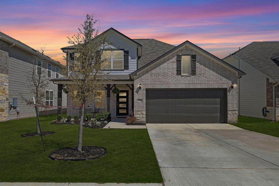 a front view of a house with a garden and plants