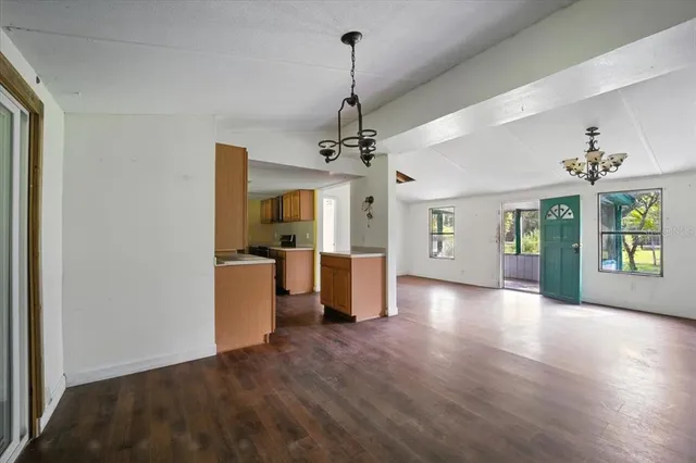 a view of a room with window and wooden floor
