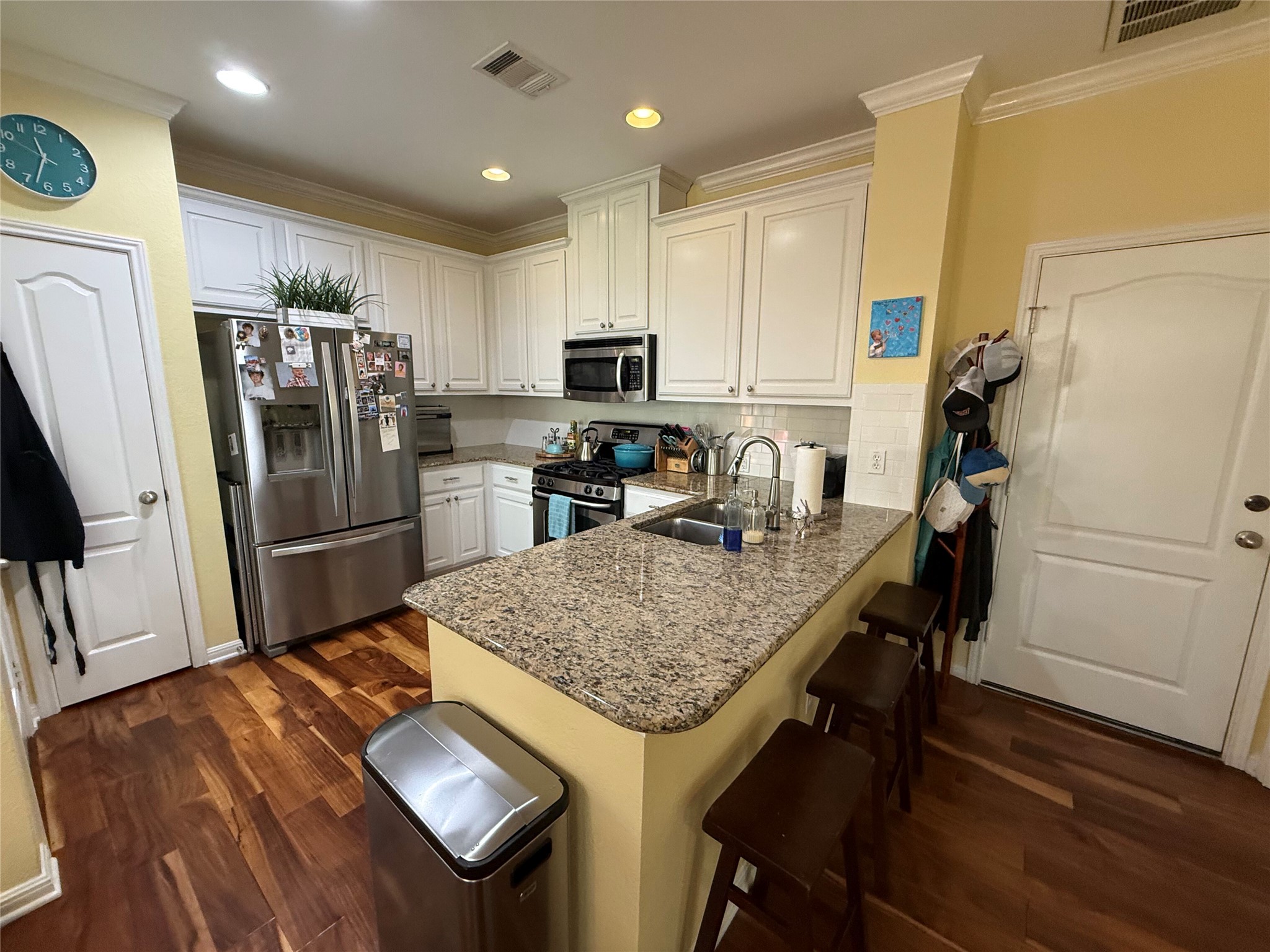 11000 Anderson Mill Road, Unit 93 Austin, TX 78750 - Photo 2 of 27 A well-appointed kitchen features rich hardwood flooring and a functional island for casual dining.