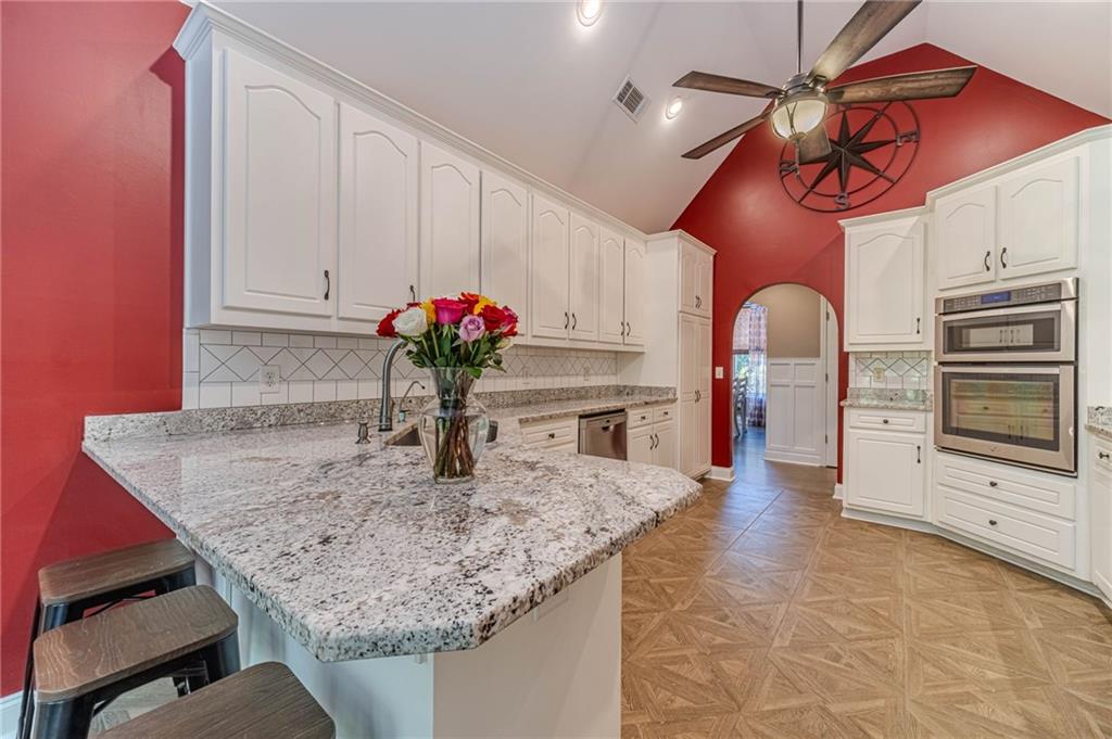4415 Locklin Road Monroe, GA 30655 - Photo 13 of 79 a kitchen with stainless steel appliances granite countertop a sink and cabinets