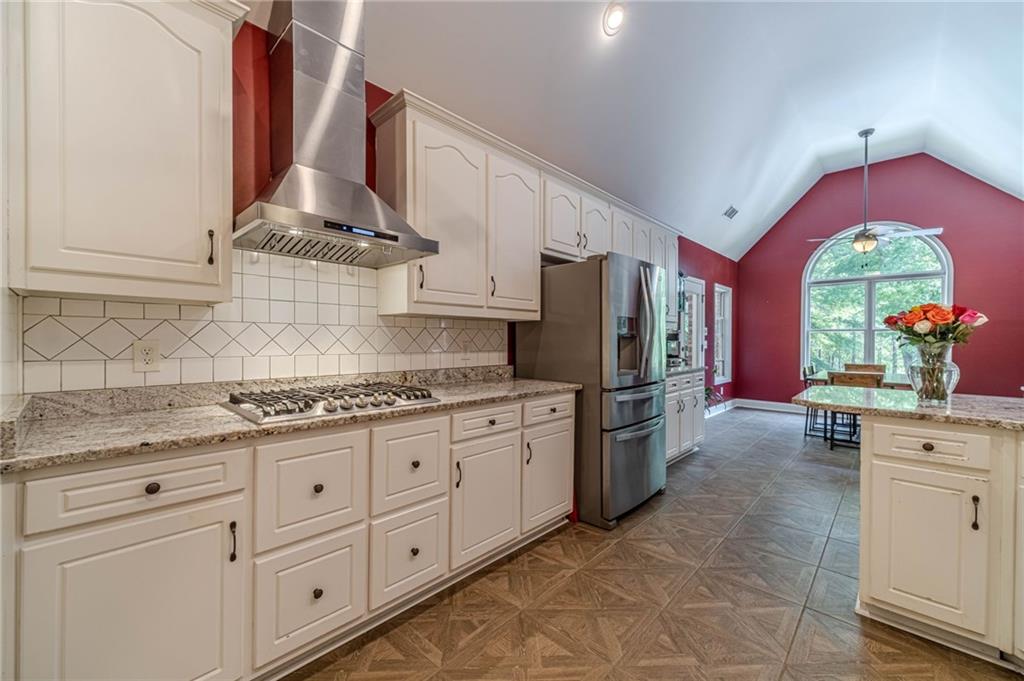 4415 Locklin Road Monroe, GA 30655 - Photo 14 of 79 a kitchen with stainless steel appliances granite countertop a stove a sink and a refrigerator
