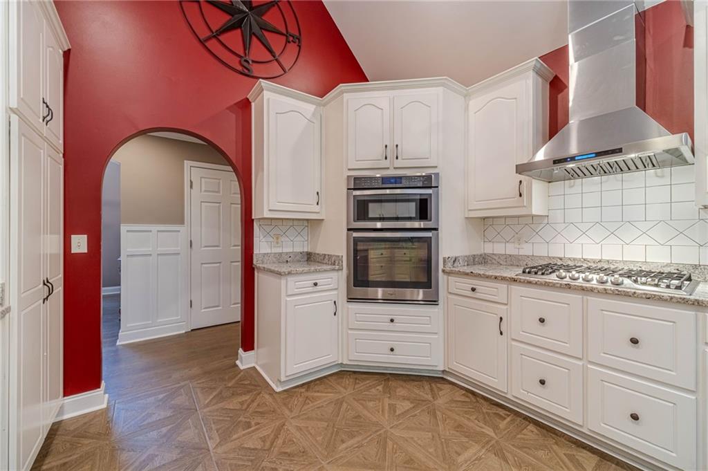 4415 Locklin Road Monroe, GA 30655 - Photo 17 of 79 a kitchen with stainless steel appliances granite countertop a stove a sink and a refrigerator