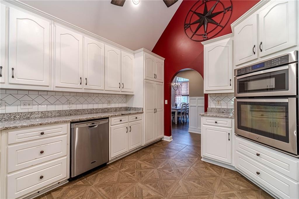 4415 Locklin Road Monroe, GA 30655 - Photo 18 of 79 a kitchen with stainless steel appliances granite countertop a stove and a microwave