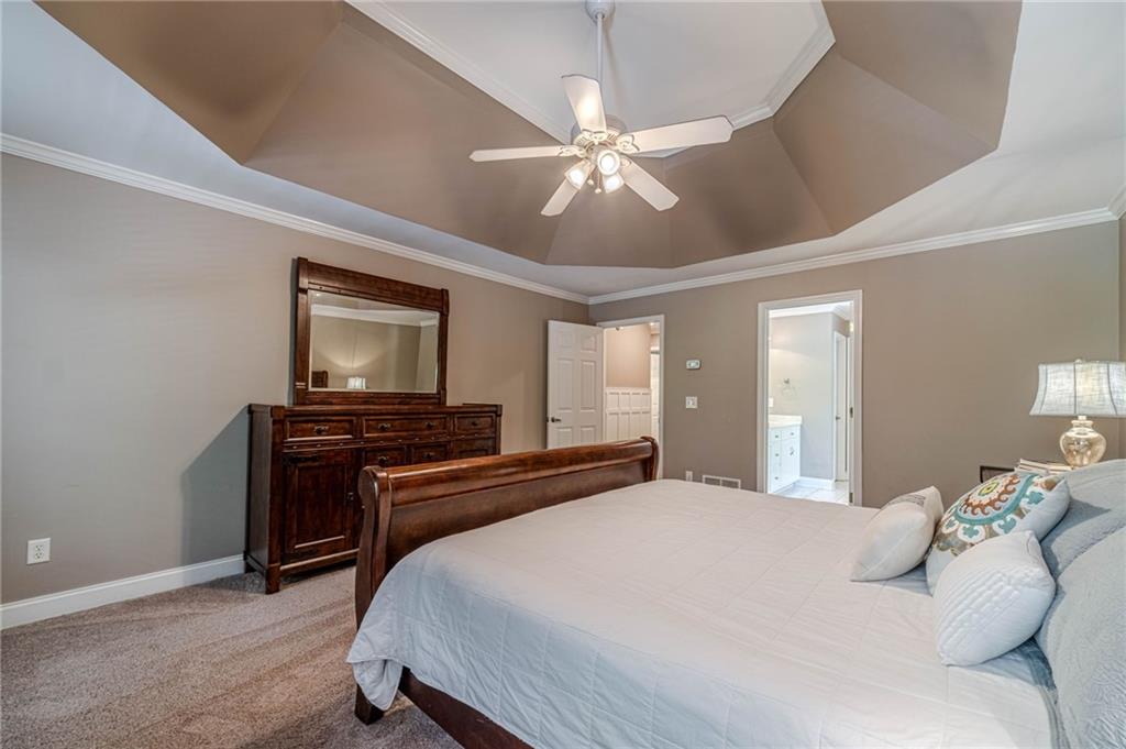 4415 Locklin Road Monroe, GA 30655 - Photo 26 of 79 a bedroom with a bed and a flat screen tv