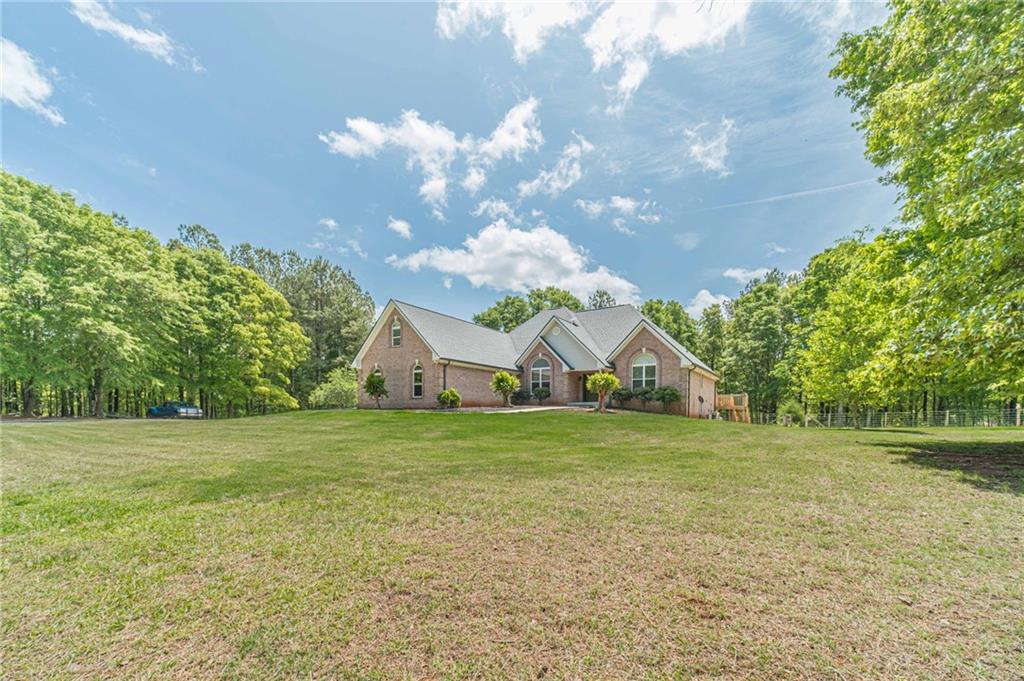 4415 Locklin Road Monroe, GA 30655 - Photo 3 of 79 a view of a big yard with a house in the background