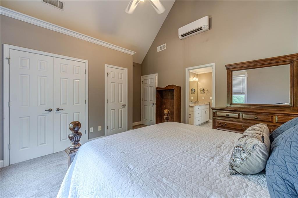 4415 Locklin Road Monroe, GA 30655 - Photo 33 of 79 a bedroom with a bed and a large mirror