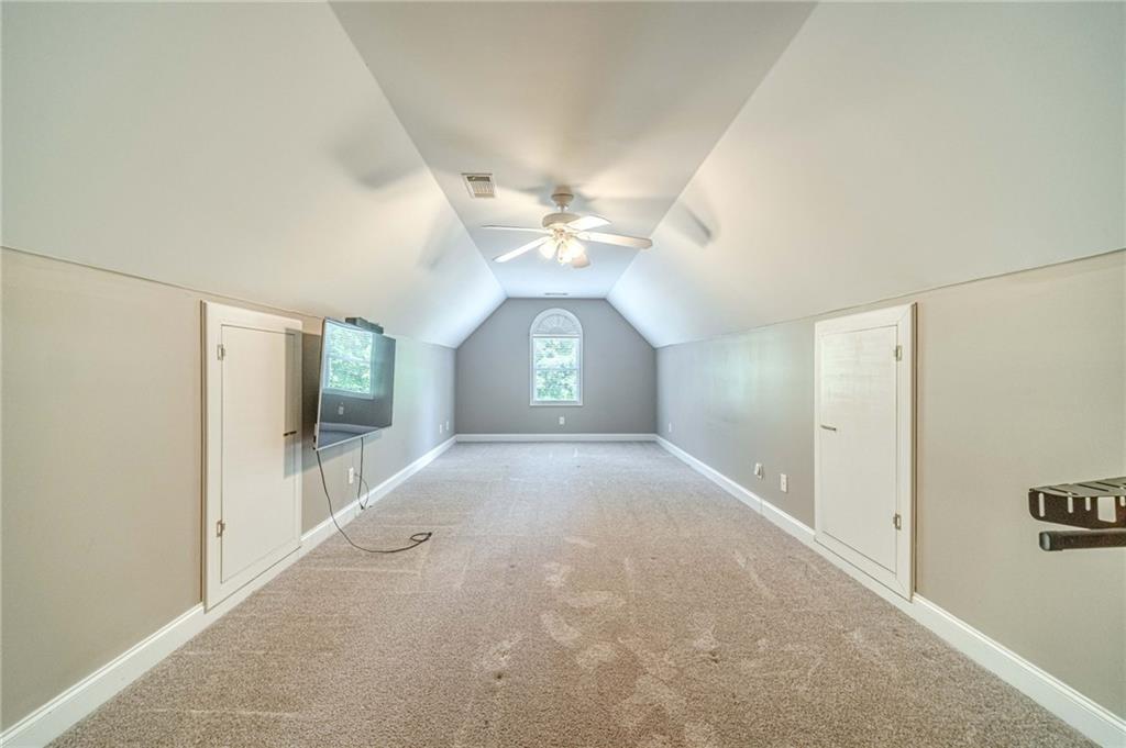 4415 Locklin Road Monroe, GA 30655 - Photo 37 of 79 a view of a hallway with a chandelier fan and windows