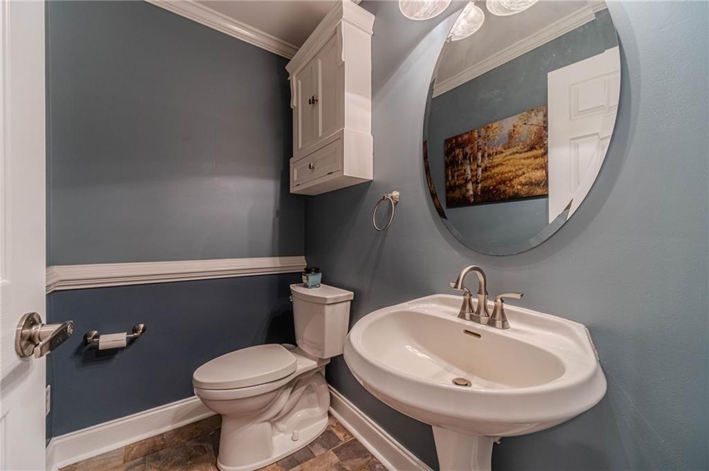 4415 Locklin Road Monroe, GA 30655 - Photo 39 of 79 a bathroom with a sink a toilet and a mirror