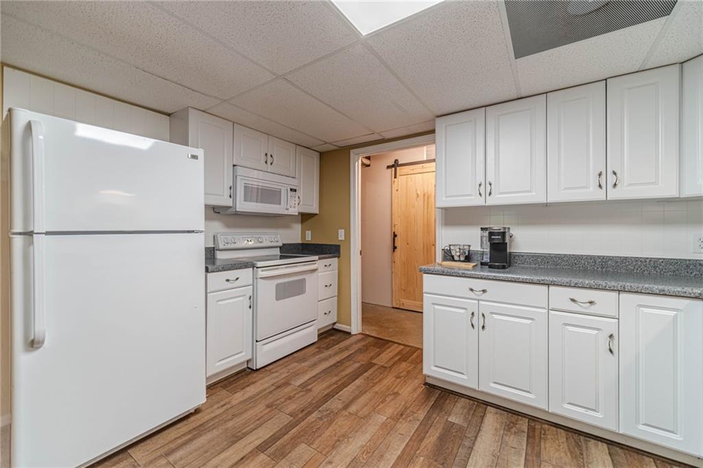 4415 Locklin Road Monroe, GA 30655 - Photo 46 of 79 a kitchen with white cabinets and white appliances