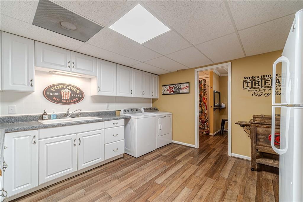 4415 Locklin Road Monroe, GA 30655 - Photo 49 of 79 a kitchen with a sink a stove top oven and cabinets