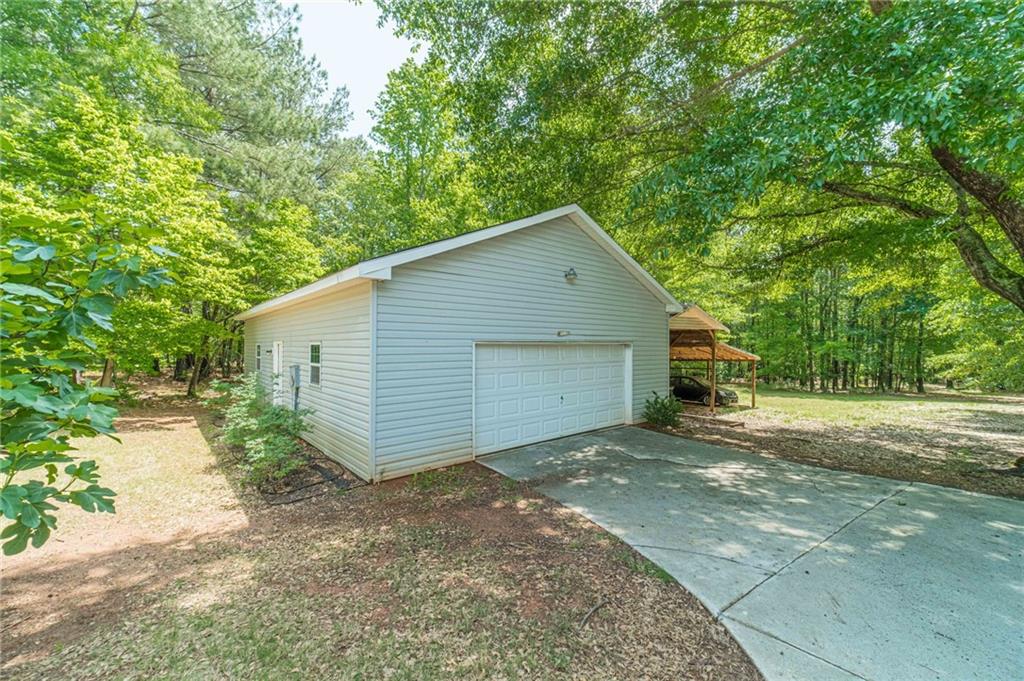 4415 Locklin Road Monroe, GA 30655 - Photo 52 of 79 a view of a house with a yard and large tree