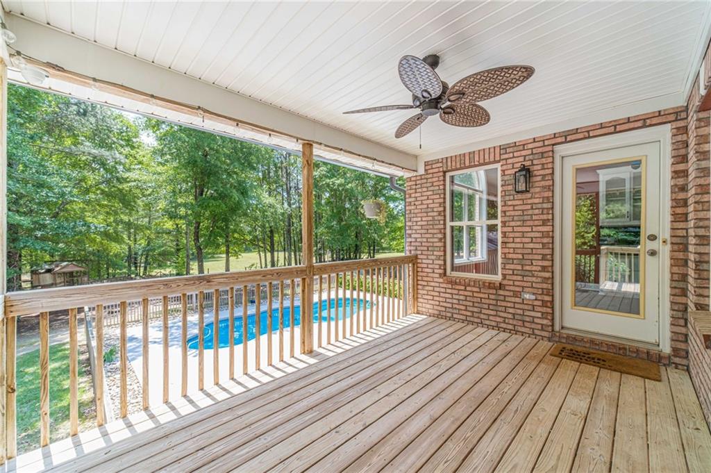 4415 Locklin Road Monroe, GA 30655 - Photo 56 of 79 a view of a porch with wooden floor in front of a house