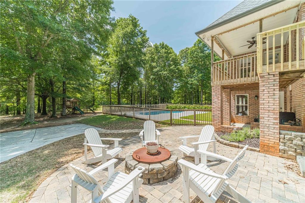 4415 Locklin Road Monroe, GA 30655 - Photo 58 of 79 a view of a patio with couches table and chairs and potted plants