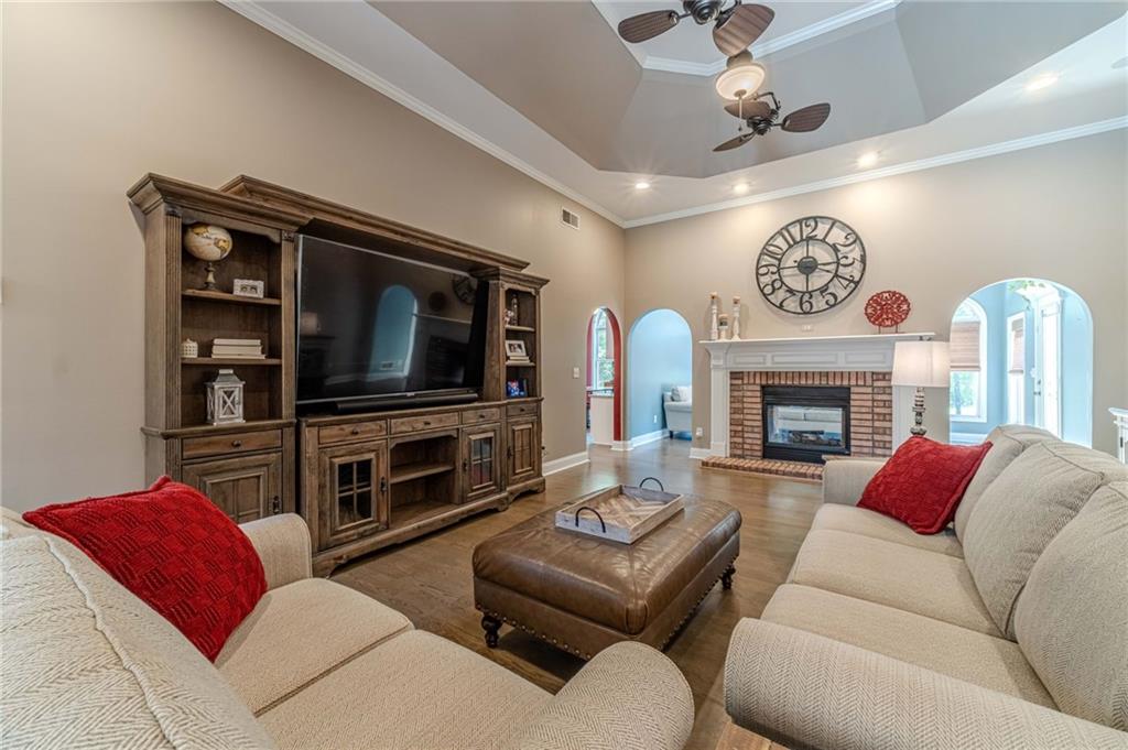 4415 Locklin Road Monroe, GA 30655 - Photo 7 of 79 a living room with furniture a flat screen tv and a fireplace