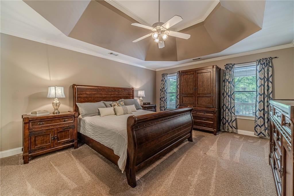 4415 Locklin Road Monroe, GA 30655 - Photo 8 of 79 a bedroom with a bed and a chandelier