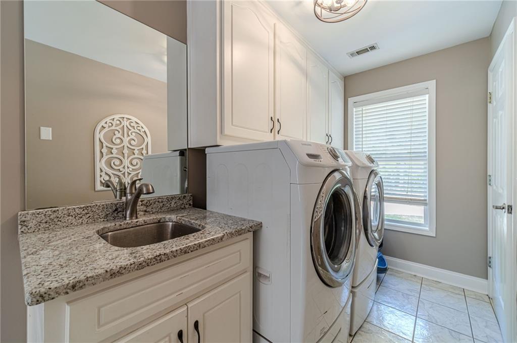 4415 Locklin Road Monroe, GA 30655 - Photo 9 of 79 a utility room with sink dryer and washer