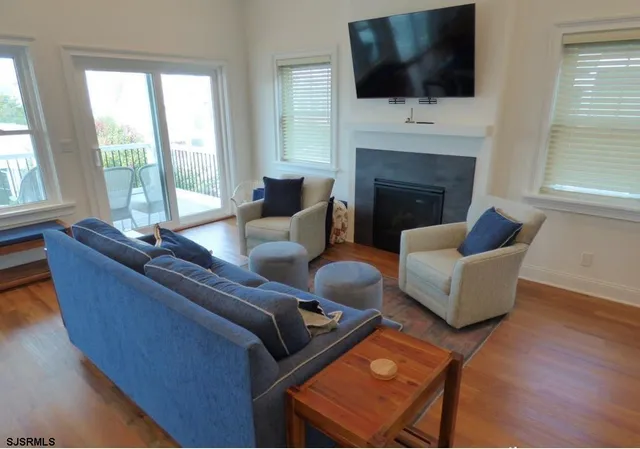 a living room with furniture fireplace and flat screen tv