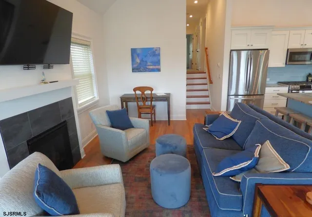 a living room with furniture fireplace and flat screen tv