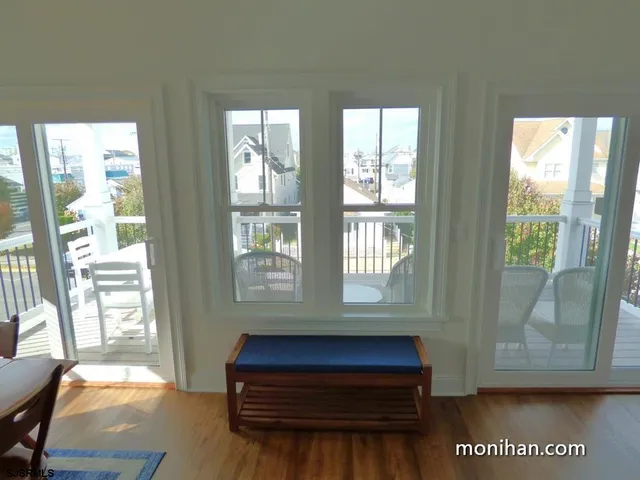 a room with pool table and windows