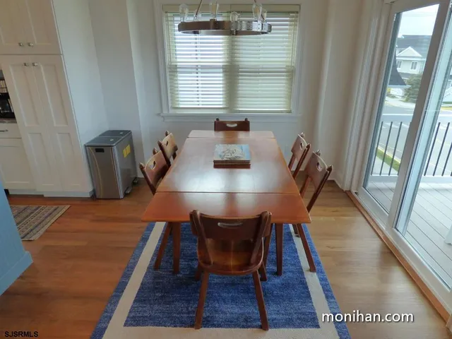 a dining room with furniture and wooden floor