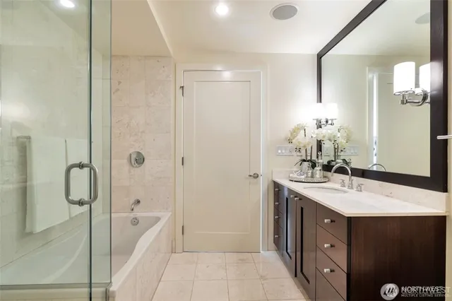 a bathroom with a double vanity sink mirror double and shower