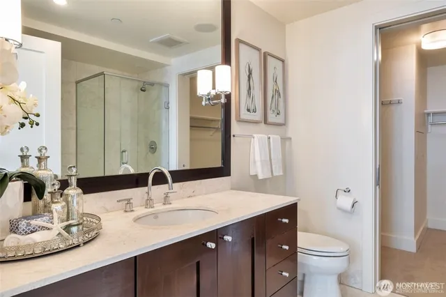 a bathroom with a double vanity sink toilet and a mirror
