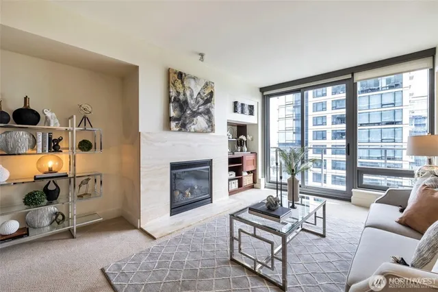 a living room with furniture a fireplace and a floor to ceiling window