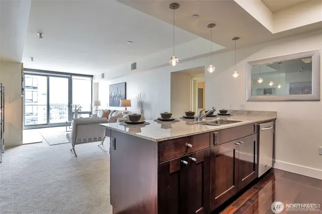 a large kitchen with kitchen island a sink appliances and a large window