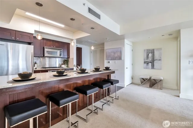 a large kitchen with a table and chairs