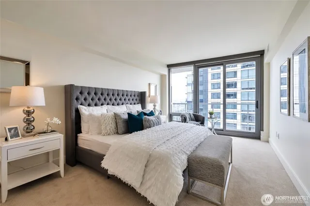 a bedroom with a bed and a large window