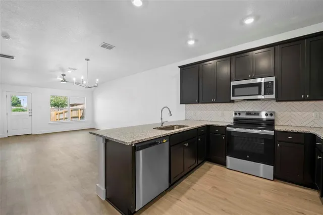 a kitchen with a sink stove and microwave