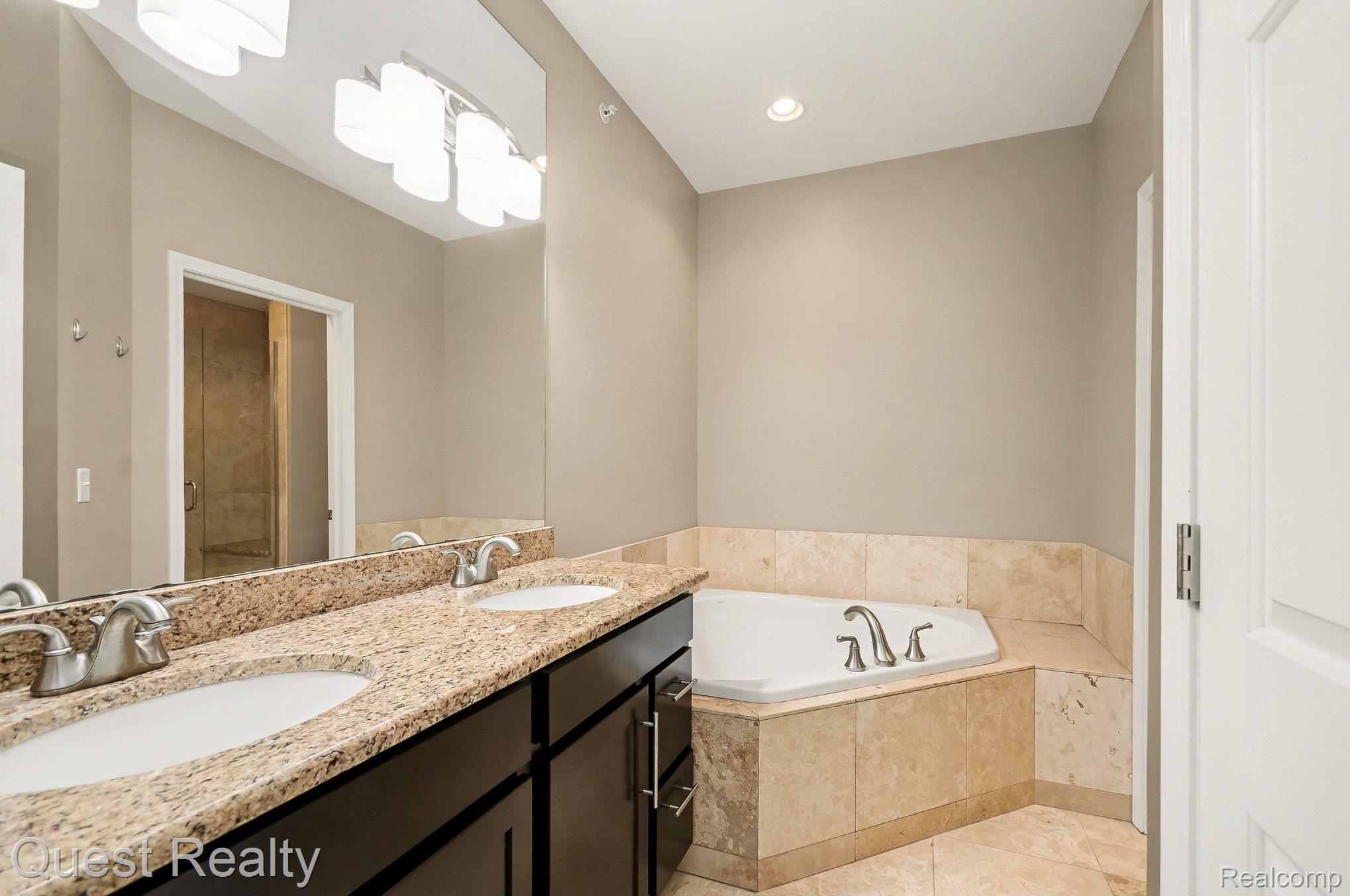 218 Mill Street Rochester, MI 48307 - Photo 17 of 34 Full bathroom with double vanity, a bath, recessed lighting, and light tile patterned flooring