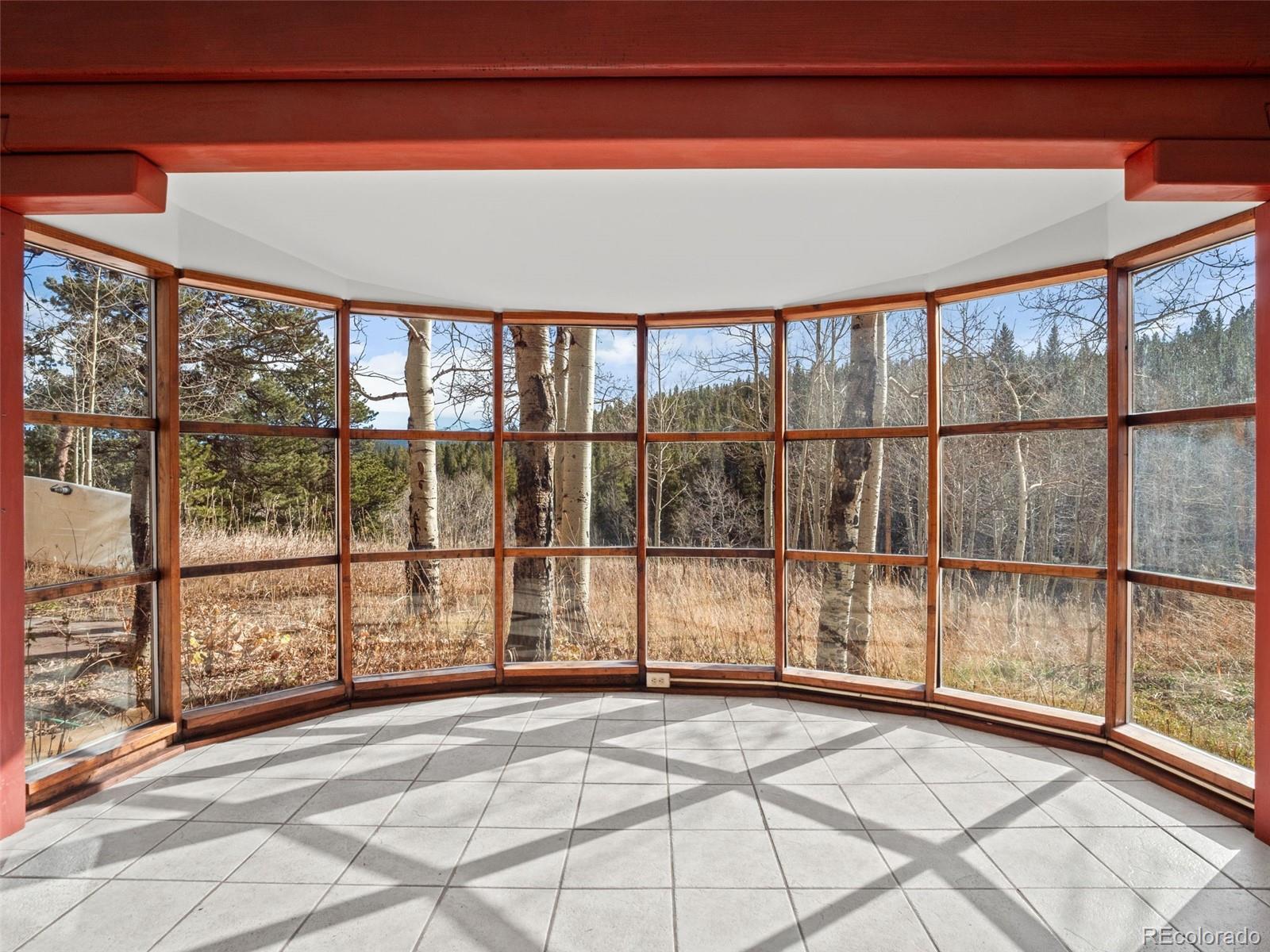 757 Lower Travis Gulch Road Black Hawk, CO 80422 - Photo 7 of 31 a view of empty room with wooden floor and fan