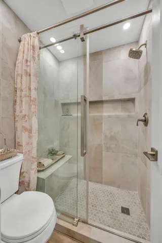 a bathroom with a shower and a toilet