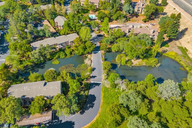 an aerial view of a house with a yard