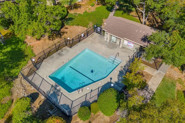 an aerial view of a house with a yard