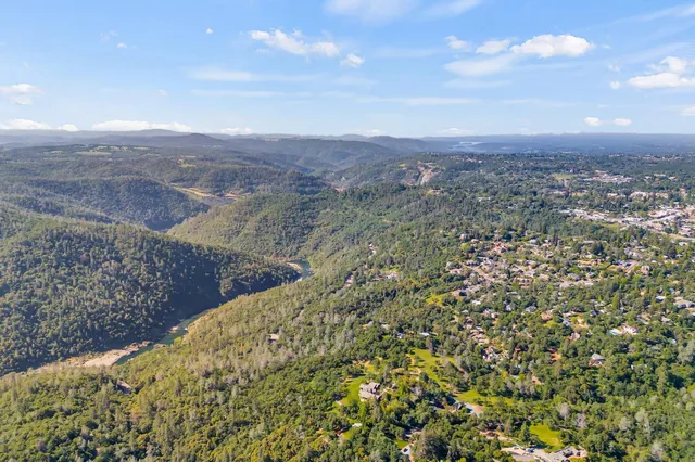 a view of a dry yard with wooden fence