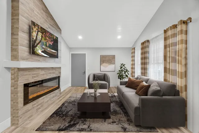 a living room with furniture wooden floor and a fireplace