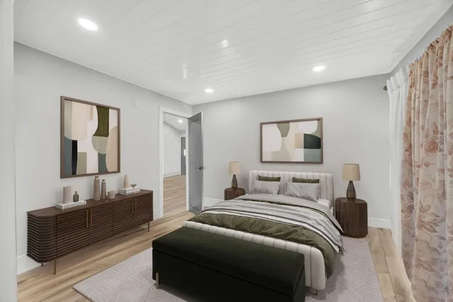 a bedroom with a bed and a couch