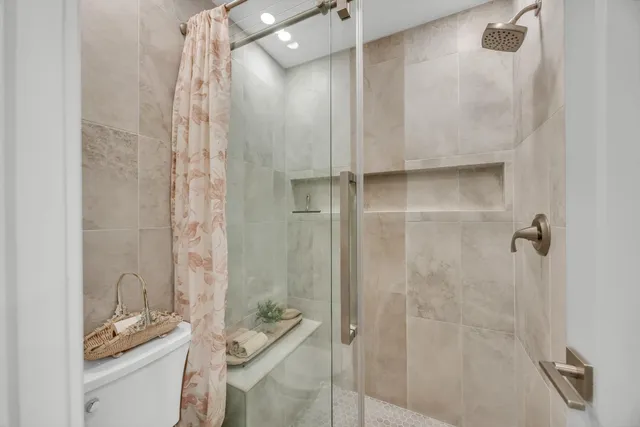 a bathroom with a granite countertop shower and a sink