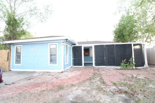 front view of house with potted plants