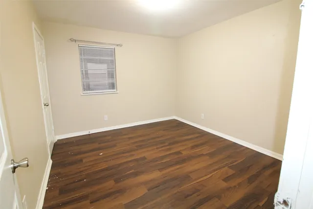 a kitchen with a stove cabinets and wooden floor