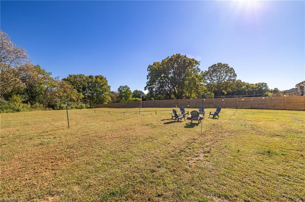 8442 Fairgrove Church Road Browns Summit, NC 27214 - Photo 22 of 24 Backyard view from the side of the home
