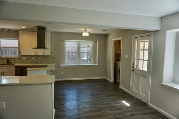 a bathroom with a granite countertop toilet sink and mirror
