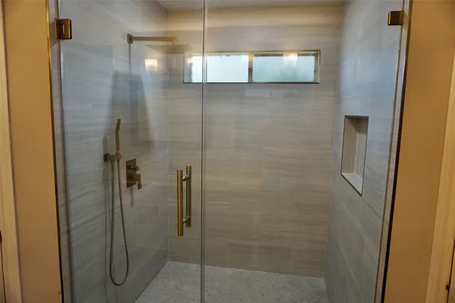 a bathroom with a shower a sink and toilet
