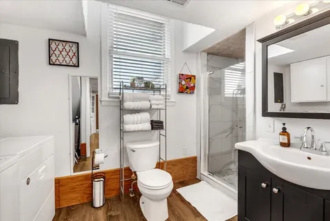 a bathroom with a sink toilet and shower