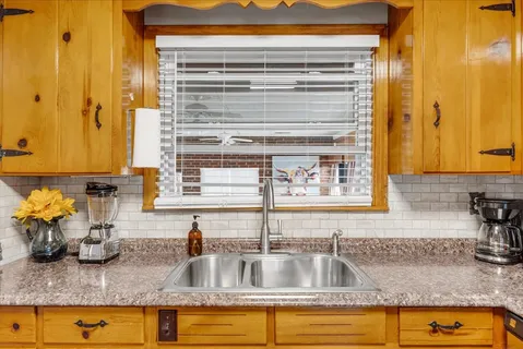 a kitchen with sink and window