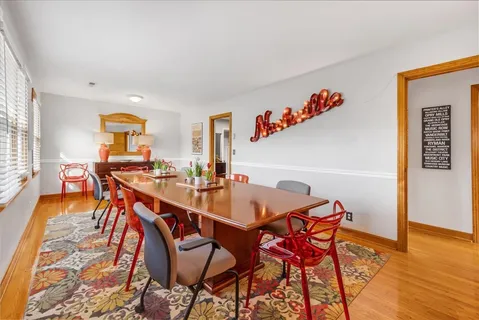 a dining room with furniture and wooden floor