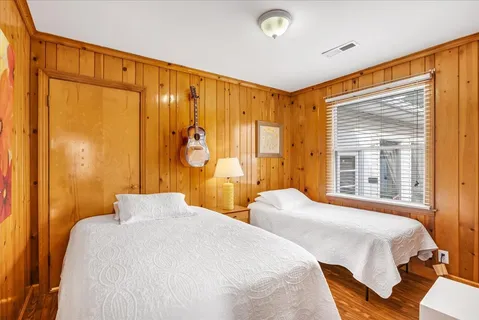 a bedroom with two beds and a table