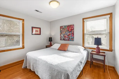 a bedroom with a bed and a large window